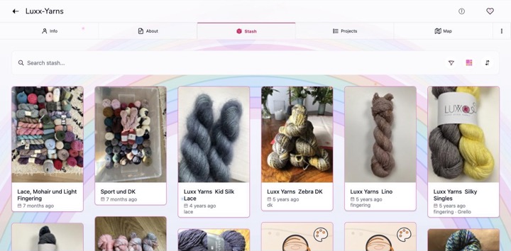 A yarn stash in the Rainbow Prism colour theme, with a rainbow behind the page