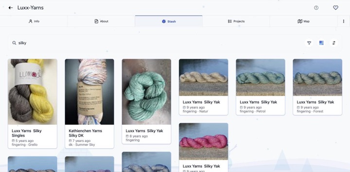 A yarn stash in the Winter Frost colour theme, with snow falling behind the page